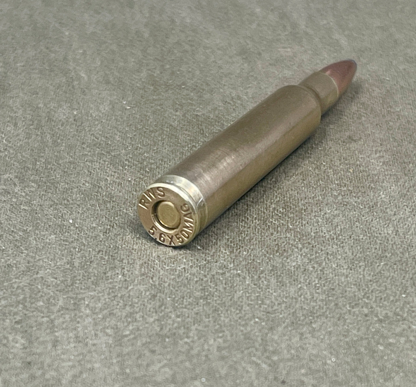 Bullet casing on a textured gray surface