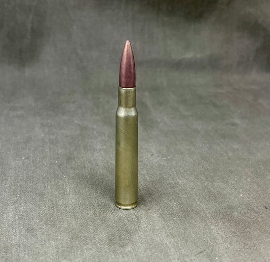 Single rifle bullet on a textured gray background