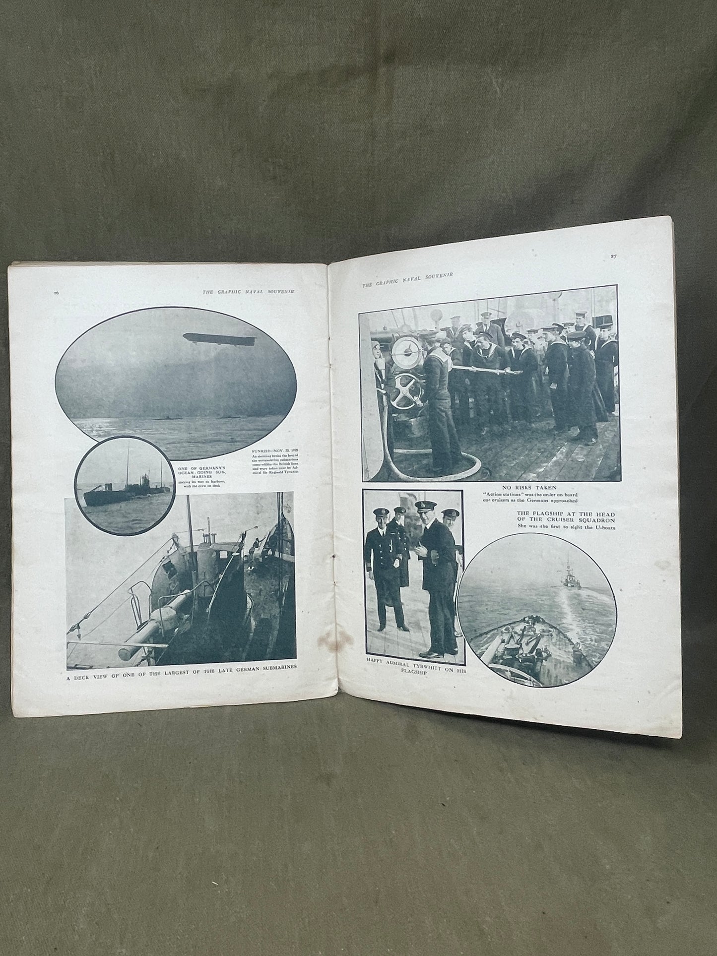 Open book with black and white photographs on a gray surface