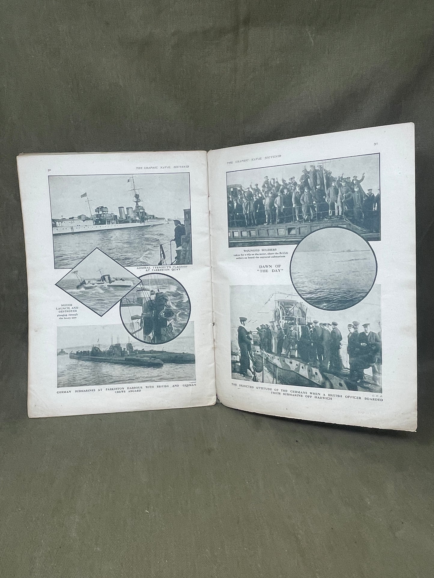 Open book with black and white photographs on a gray surface