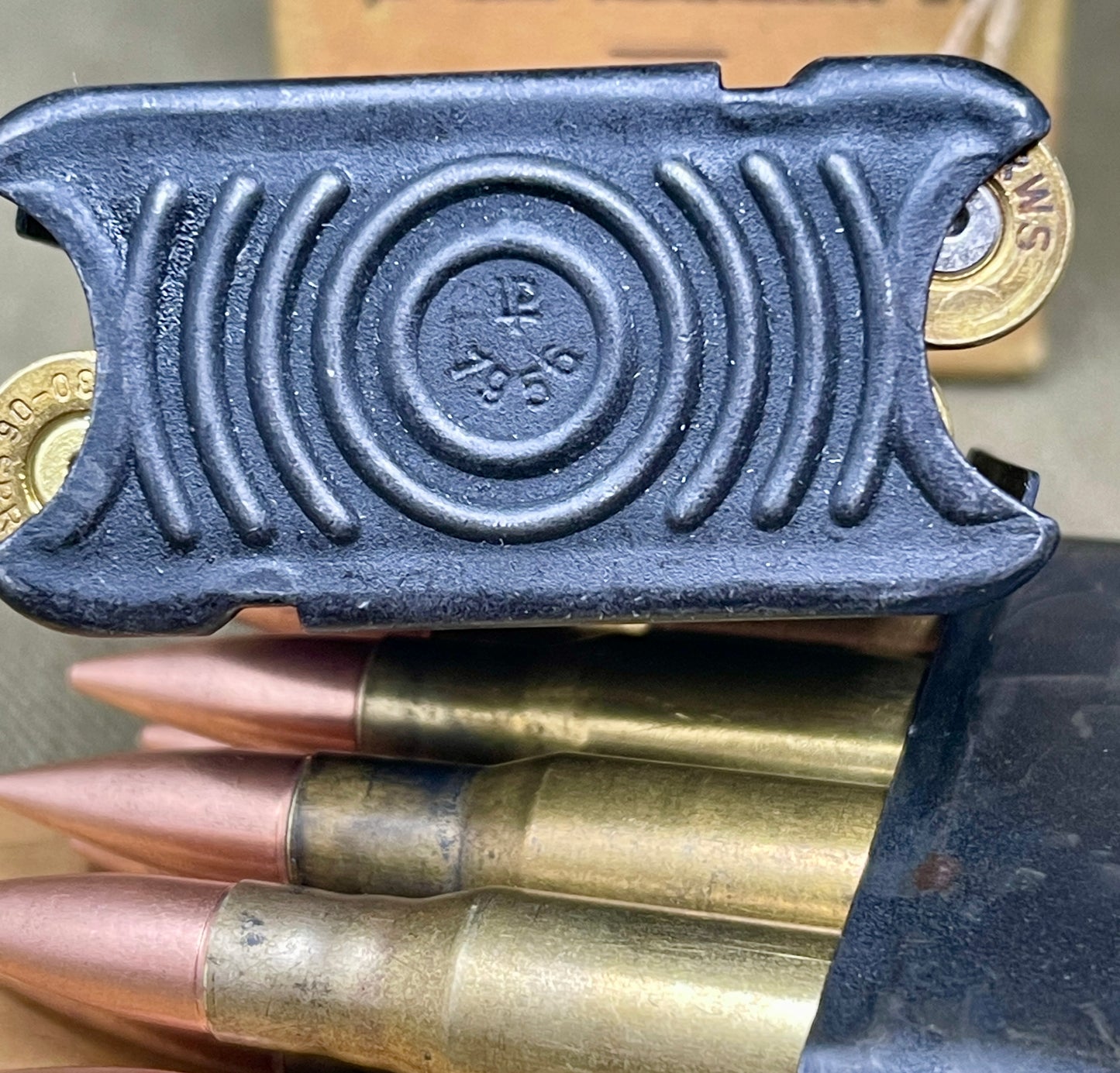 Black powder charge with brass cartridges on a wooden surface