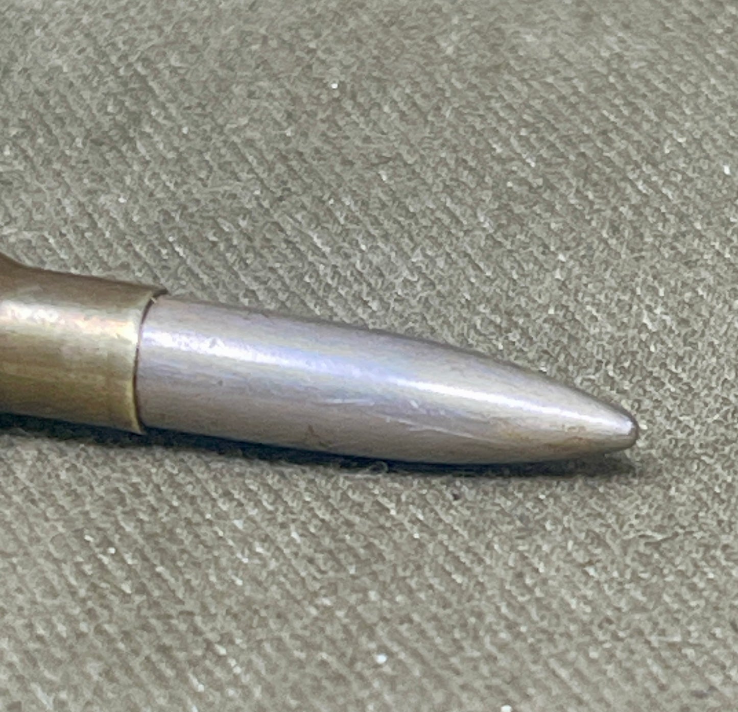 Metallic bullet on a textured surface
