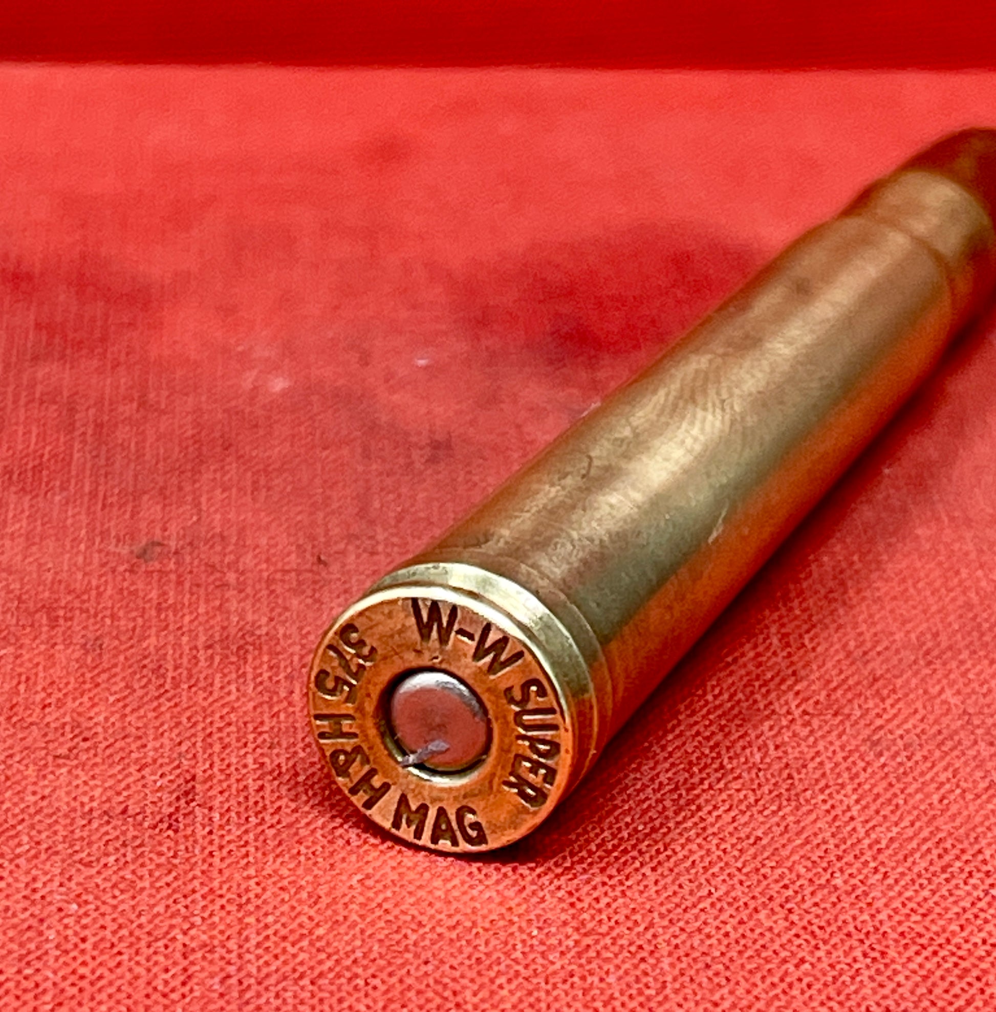 "Explore the INERT H&H .375 Magnum W-W Super Cartridge, a deactivated collectible showcasing big game hunting history and exceptional craftsmanship."