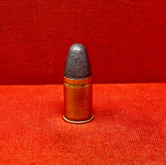 The .455 INERT British Wartime Round with the E C II headstamp is a highly detailed, safe-to-handle replica of a historical cartridge used during the early 20th century. This inert round is a non-functional reproduction, meaning it contains no live components such as primer, powder, or projectile, making it ideal for collectors, educators, or firearm enthusiasts who wish to study or display wartime ammunition without risk.
The .455 cartridge was widely used in both World Wars, particularly in revolvers lik