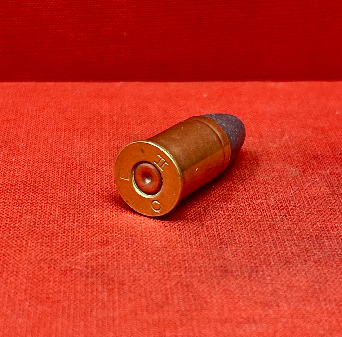 The .455 INERT British Wartime Round with the E C II headstamp is a highly detailed, safe-to-handle replica of a historical cartridge used during the early 20th century. This inert round is a non-functional reproduction, meaning it contains no live components such as primer, powder, or projectile, making it ideal for collectors, educators, or firearm enthusiasts who wish to study or display wartime ammunition without risk.
The .455 cartridge was widely used in both World Wars, particularly in revolvers lik