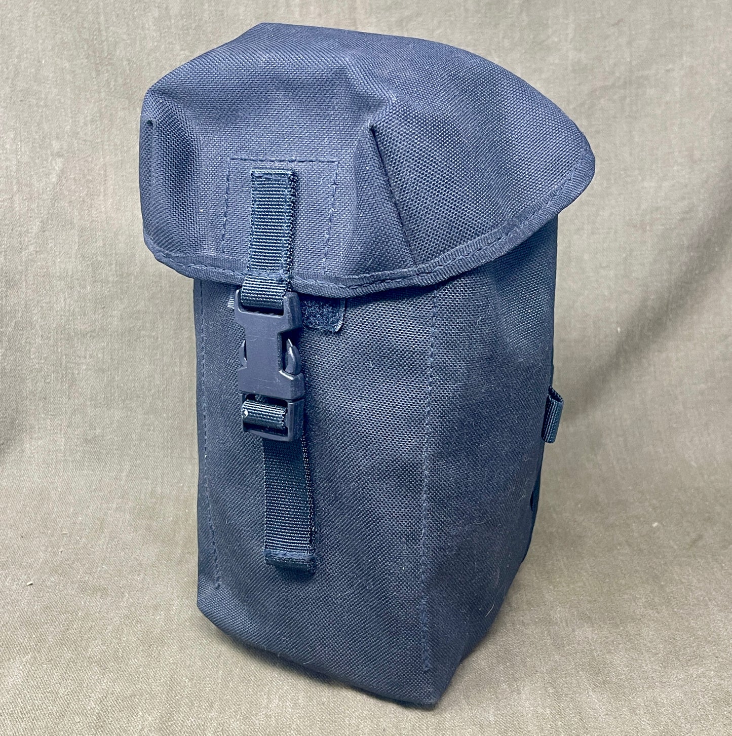 Blue tactical pouch on a beige background
