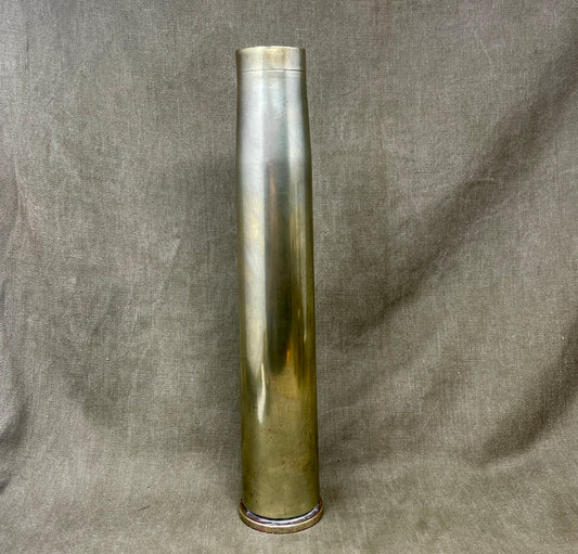 Tall cylindrical metallic object on a textured gray background