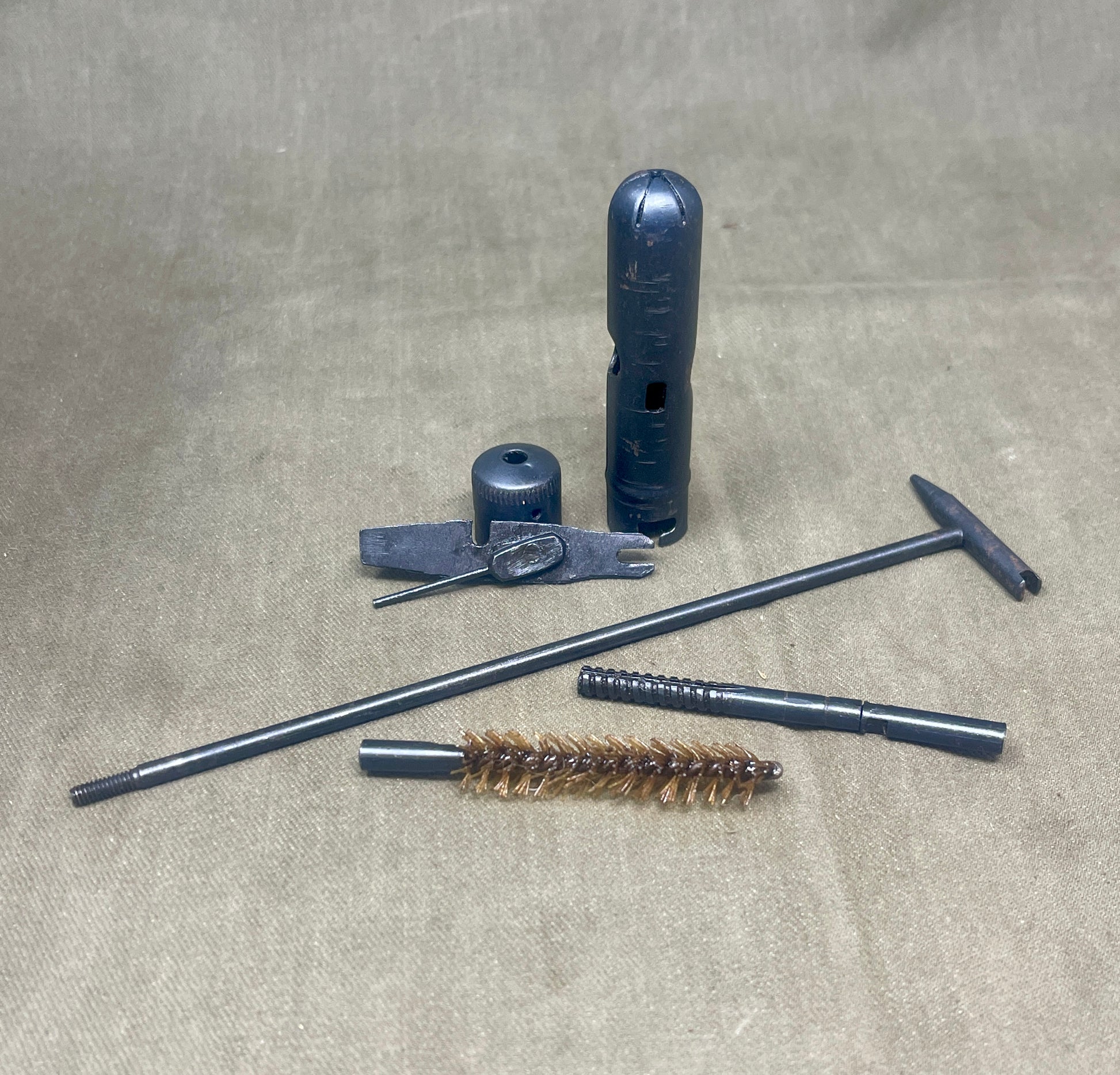 Set of gun cleaning tools on a textured surface