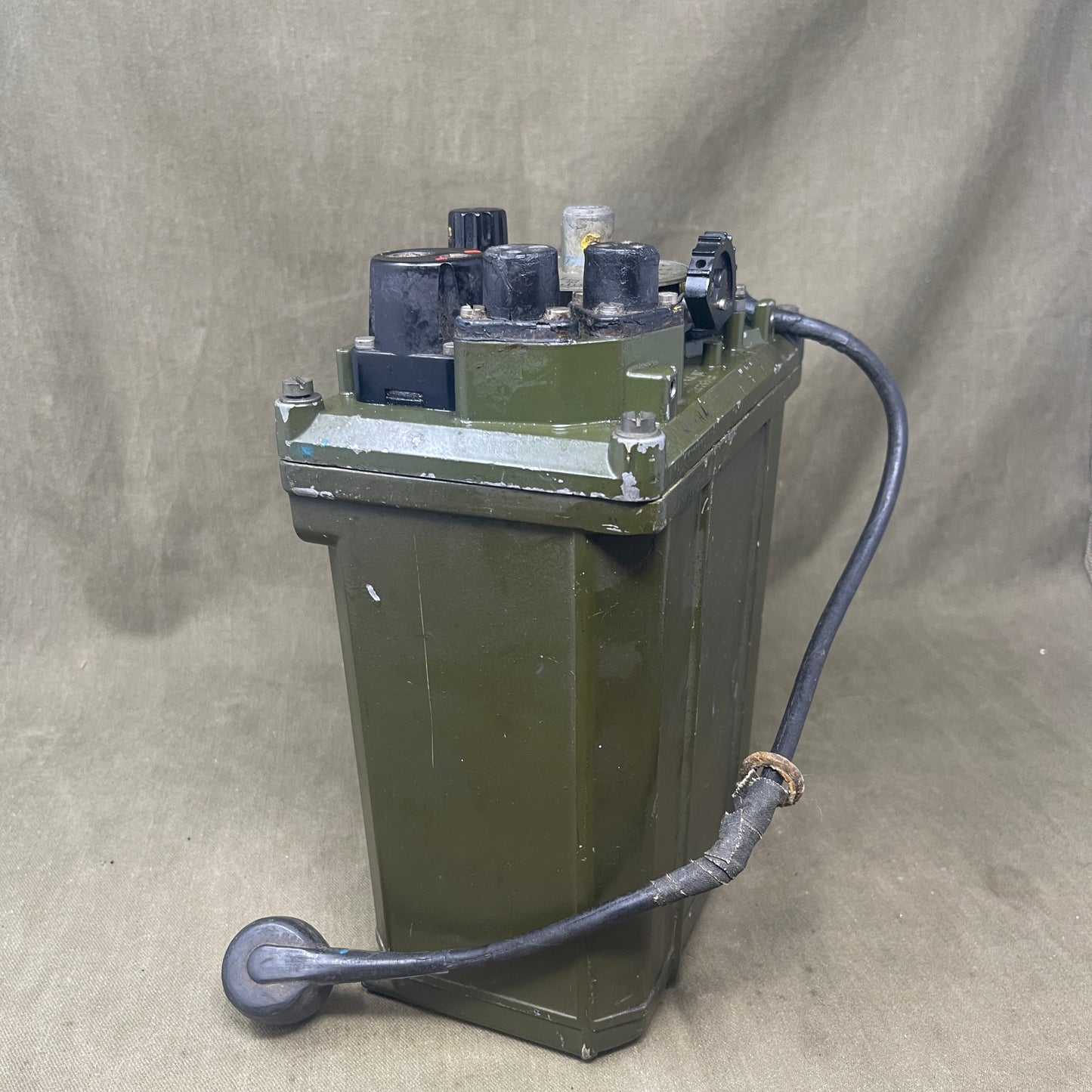 Green electrical box with wiring on a beige background