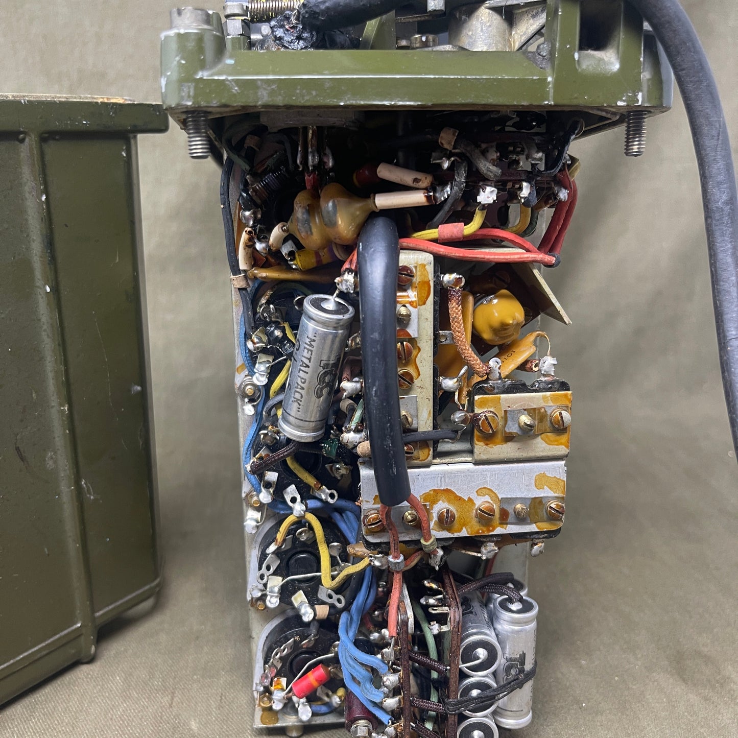 Electrical component with various wires and connectors on a beige surface