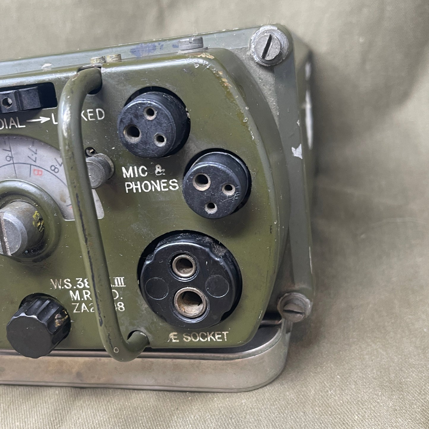 Vintage radio receiver with multiple connectors on a beige background