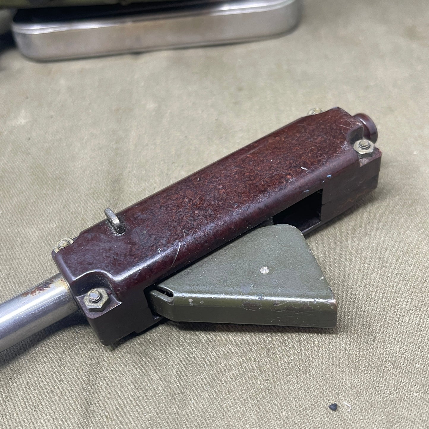 Close-up of a mechanical tool on a textured surface