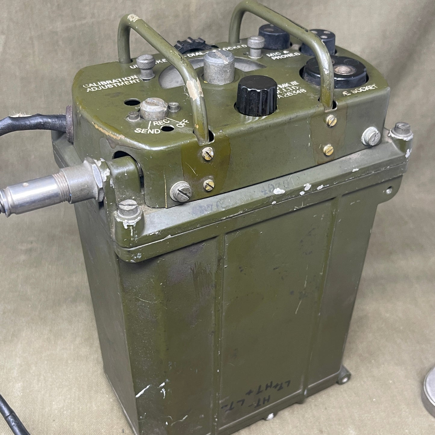 Green electronic device with various components on a beige surface