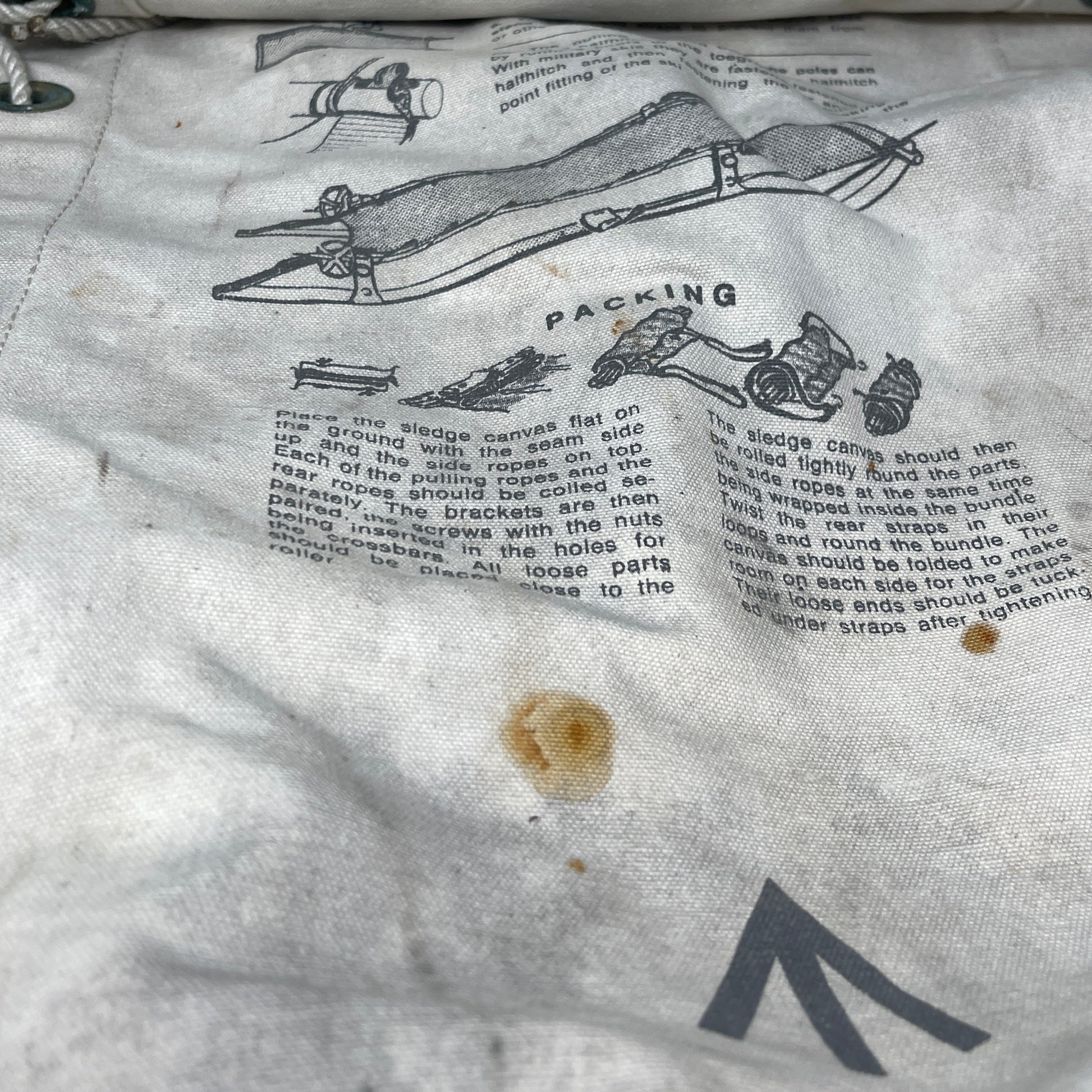 Close-up of a person's arm with tattoos of text and illustrations on a white background.