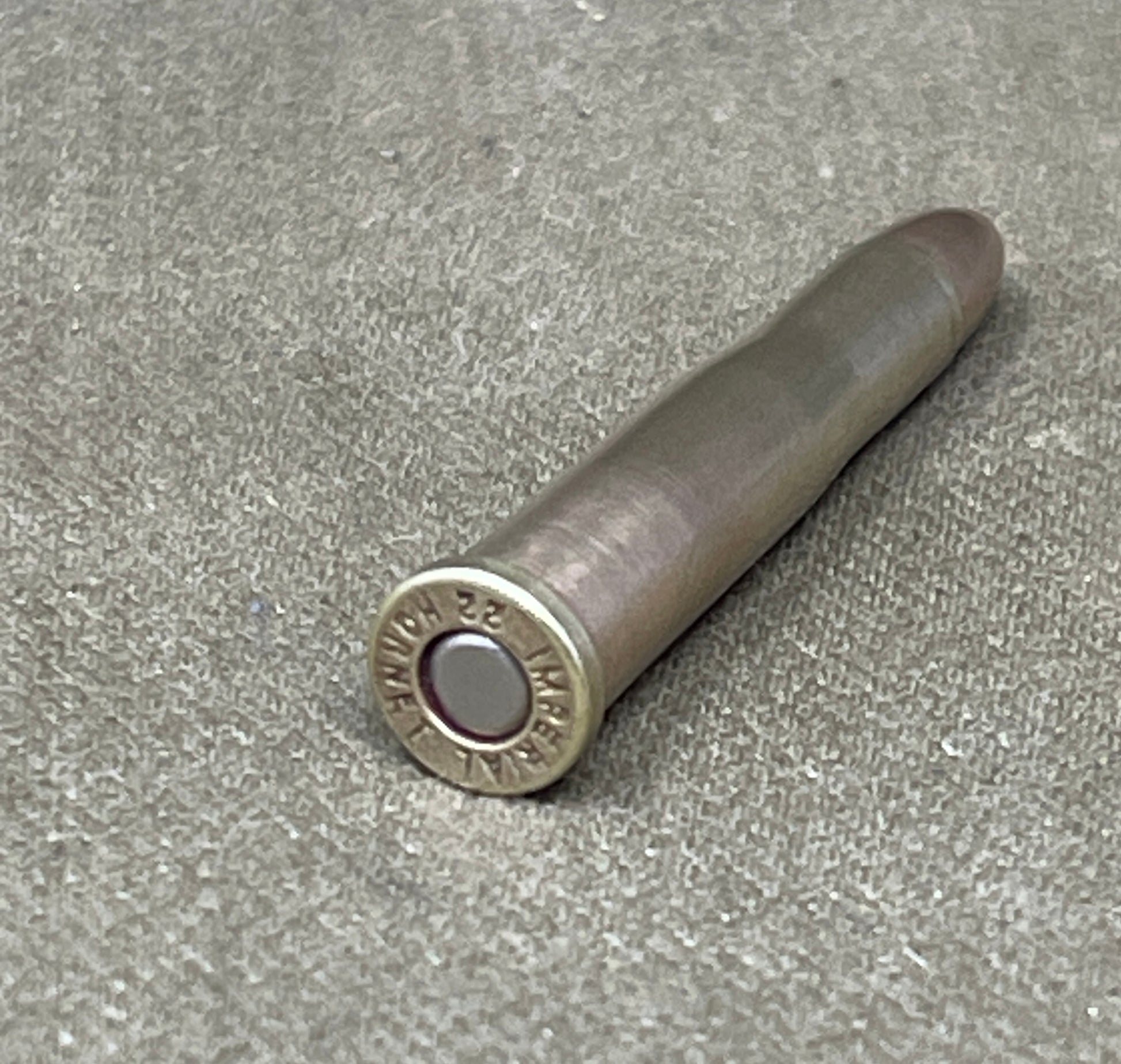 Ammunition casing on a gray surface