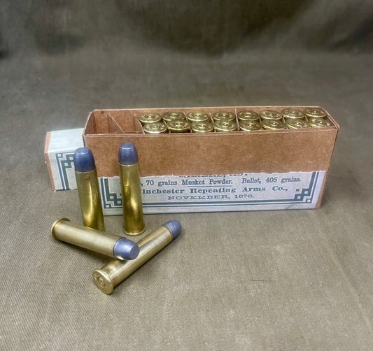 Box of ammunition with cartridges on a textured surface