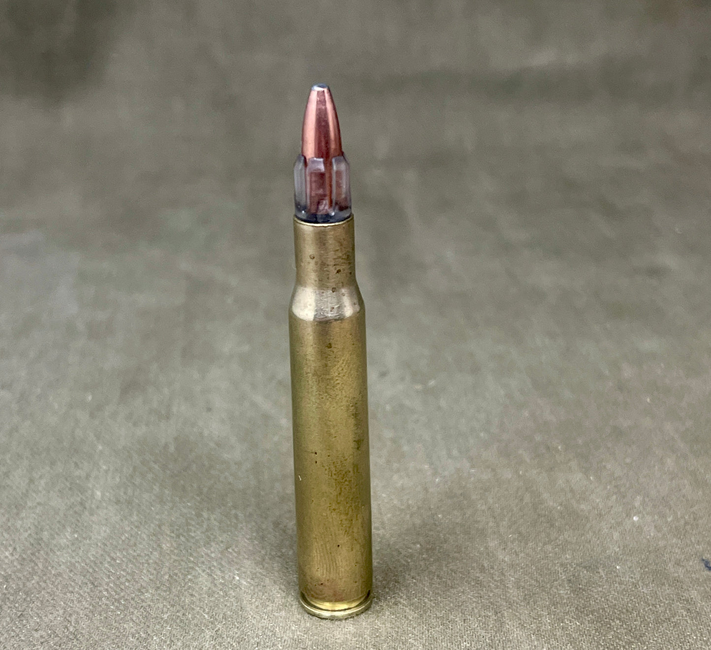 Bullet casing on a textured gray background