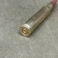 Bullet casing on a gray surface