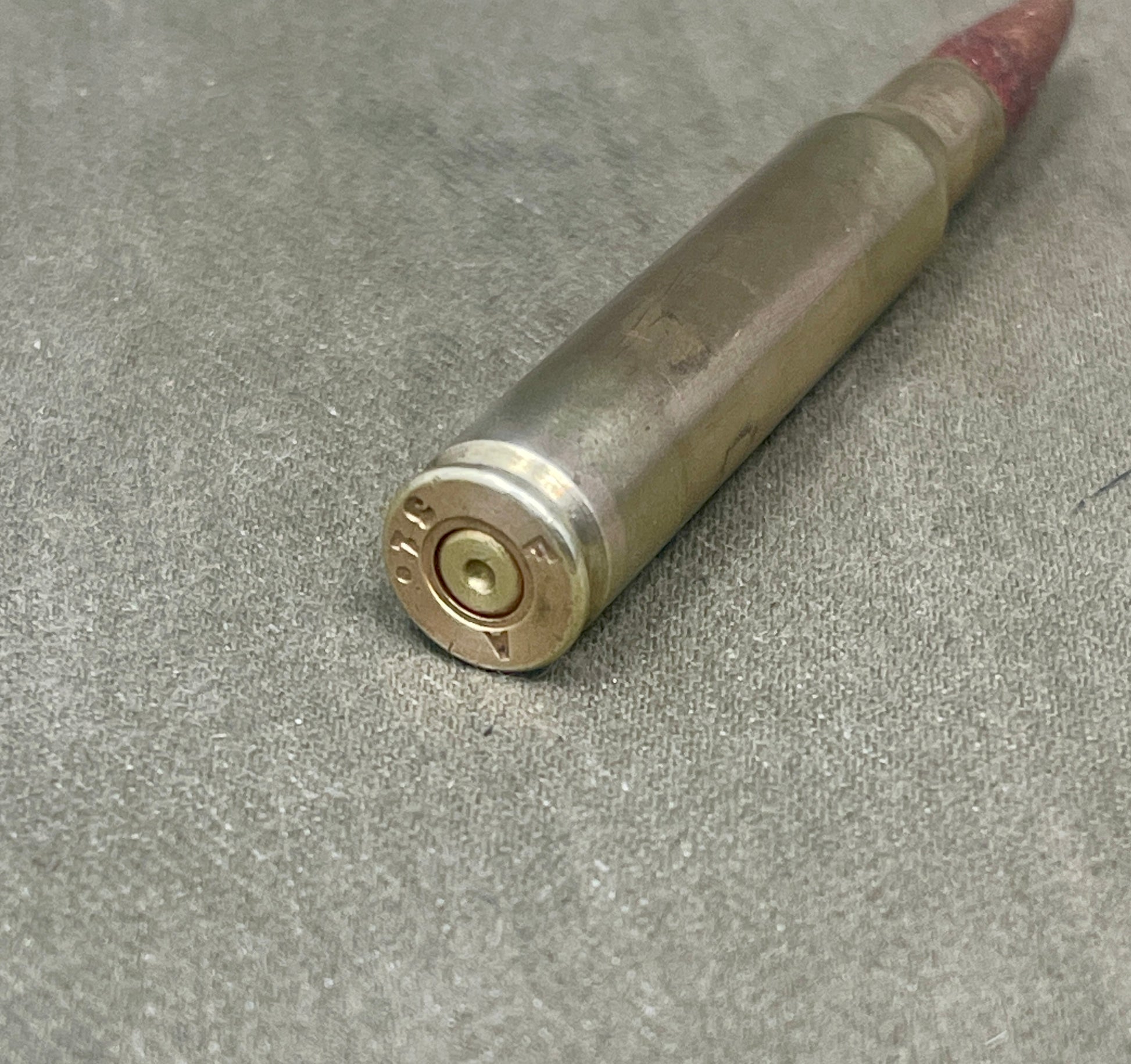 Bullet casing on a gray surface