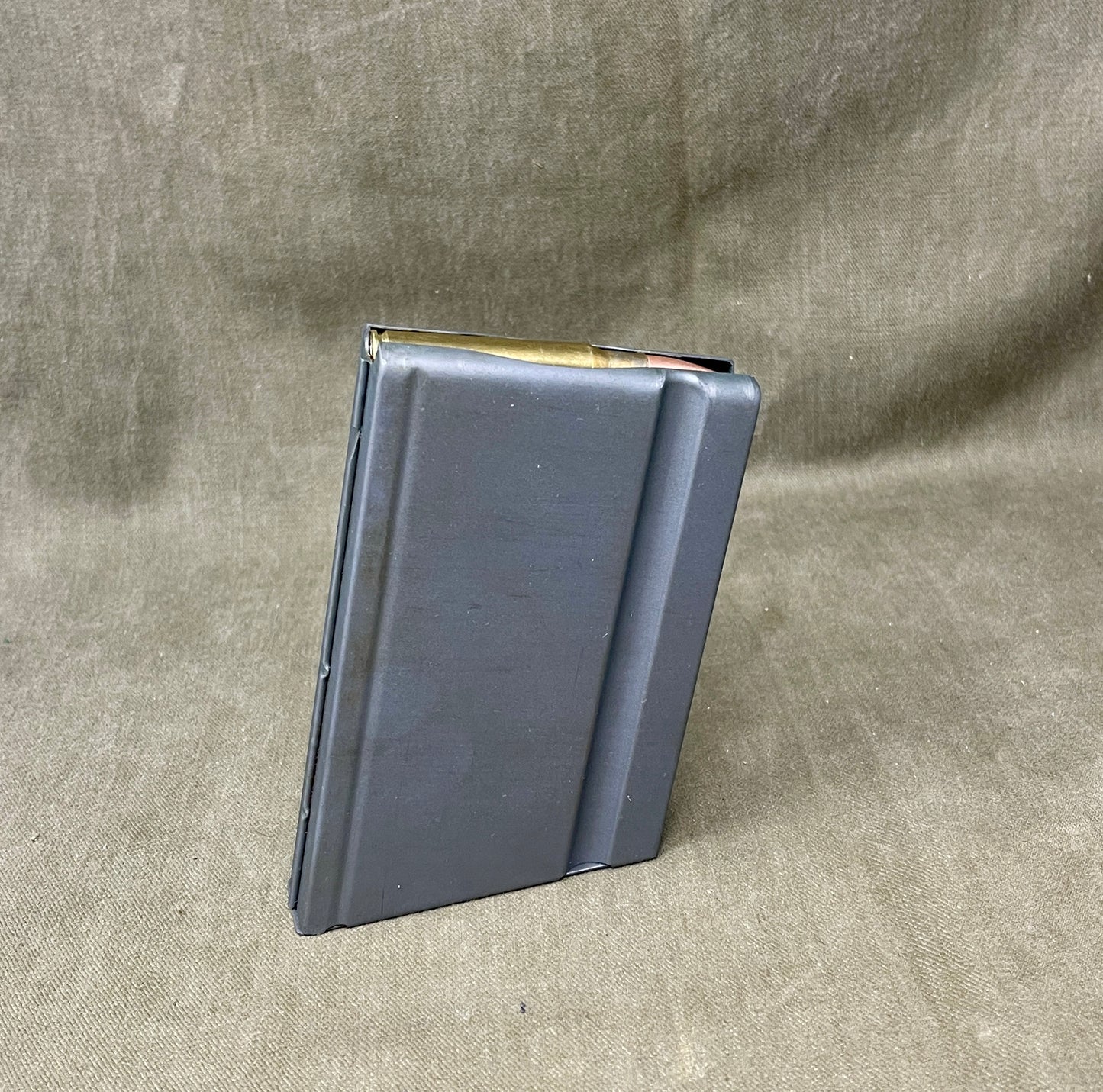 Black leather wallet on a textured beige background