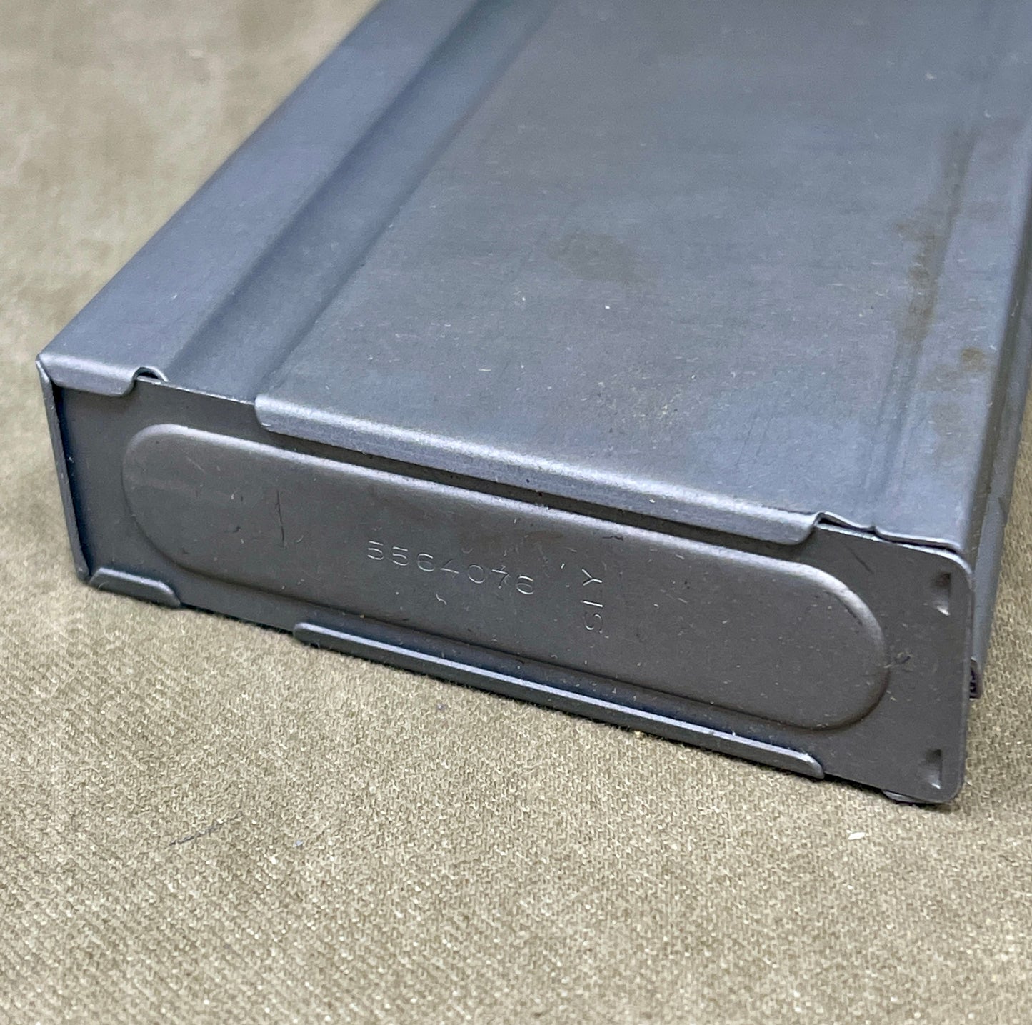 Black metal magazine on a concrete surface