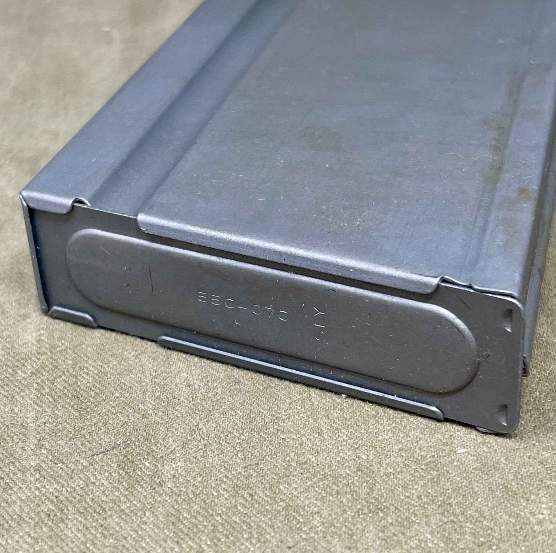 Black metal magazine on a concrete surface