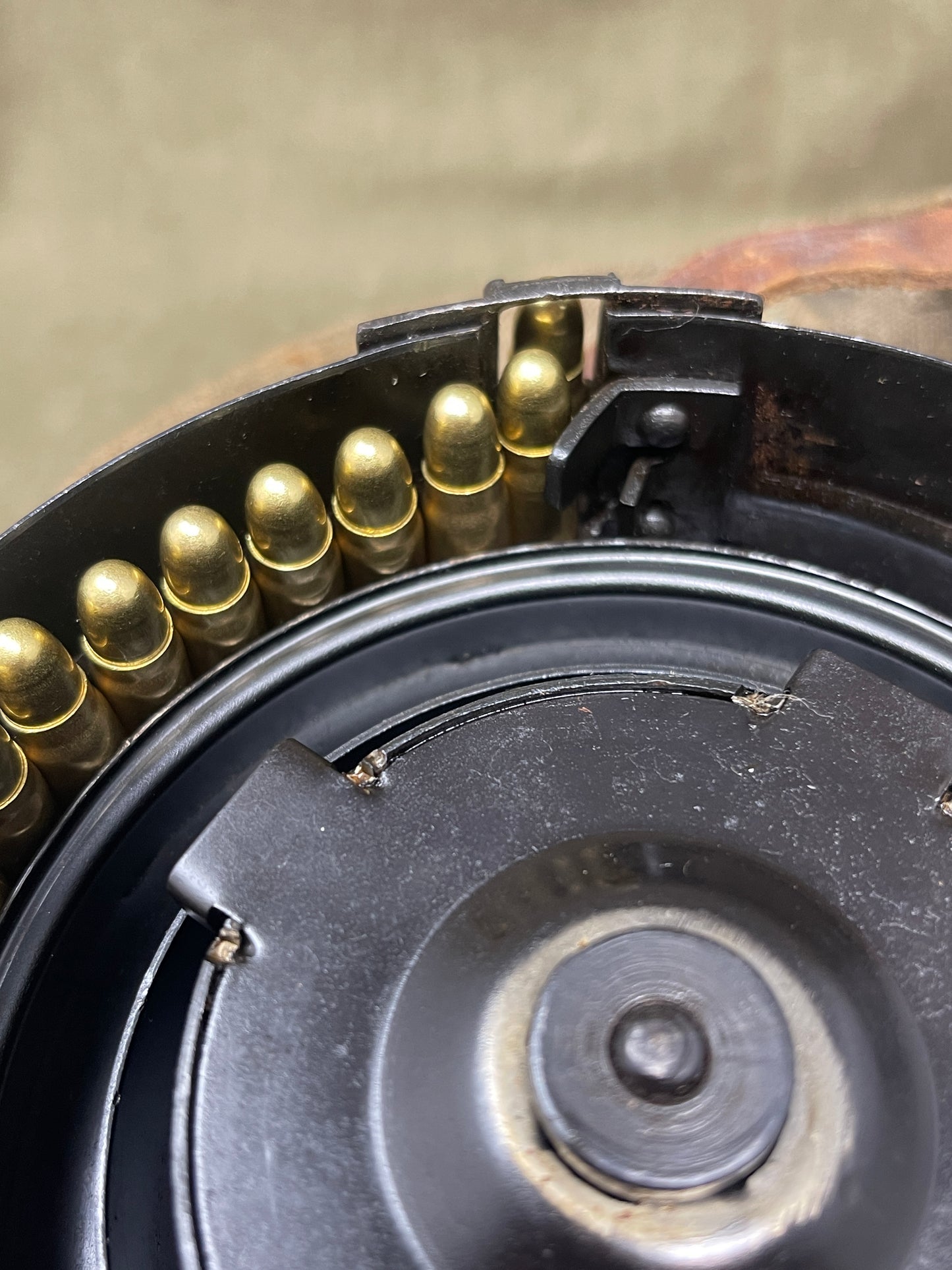 Close-up of a firearm magazine with bullets and a black metal casing.