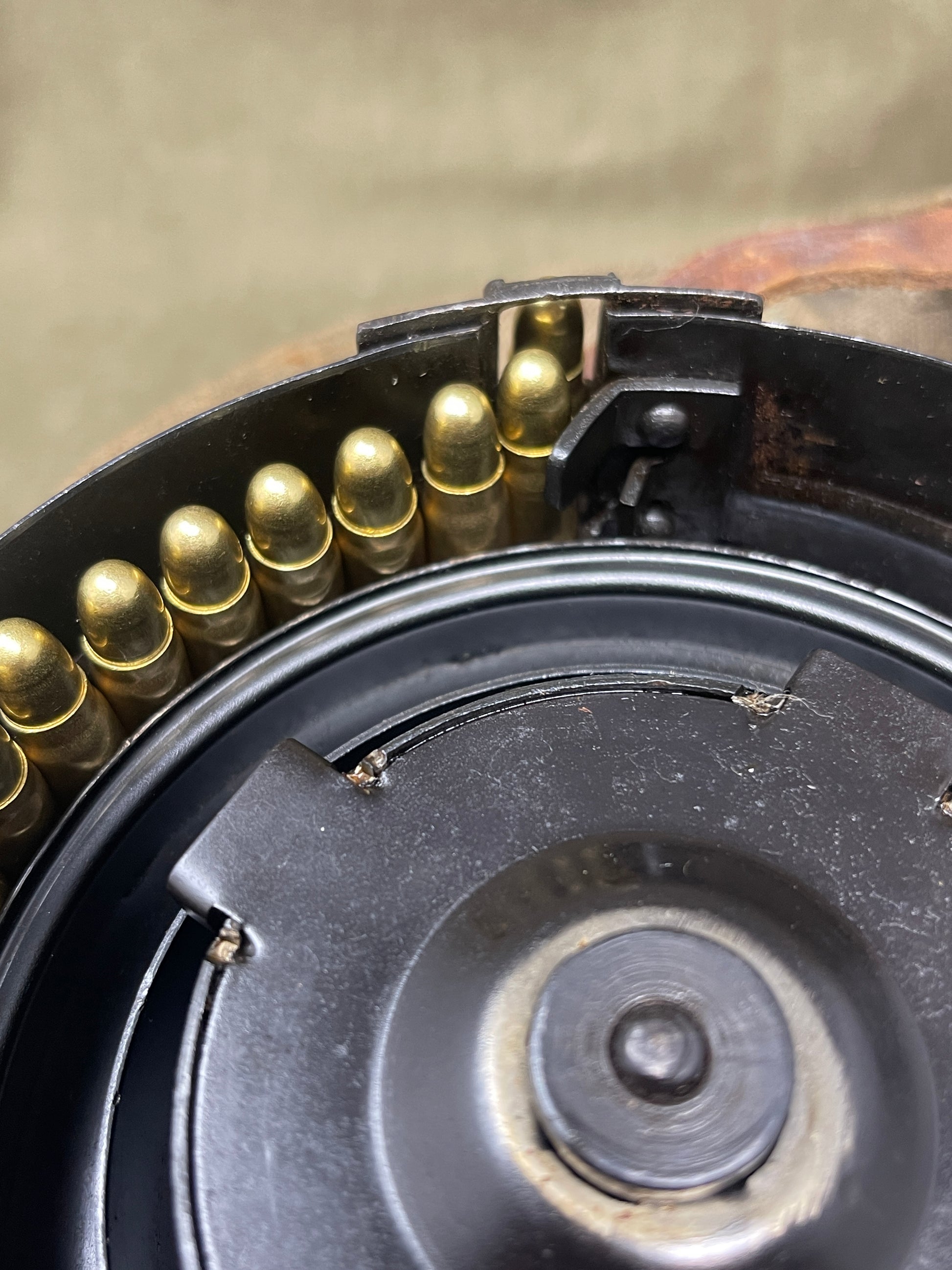 Close-up of a firearm magazine with bullets and a black metal casing.