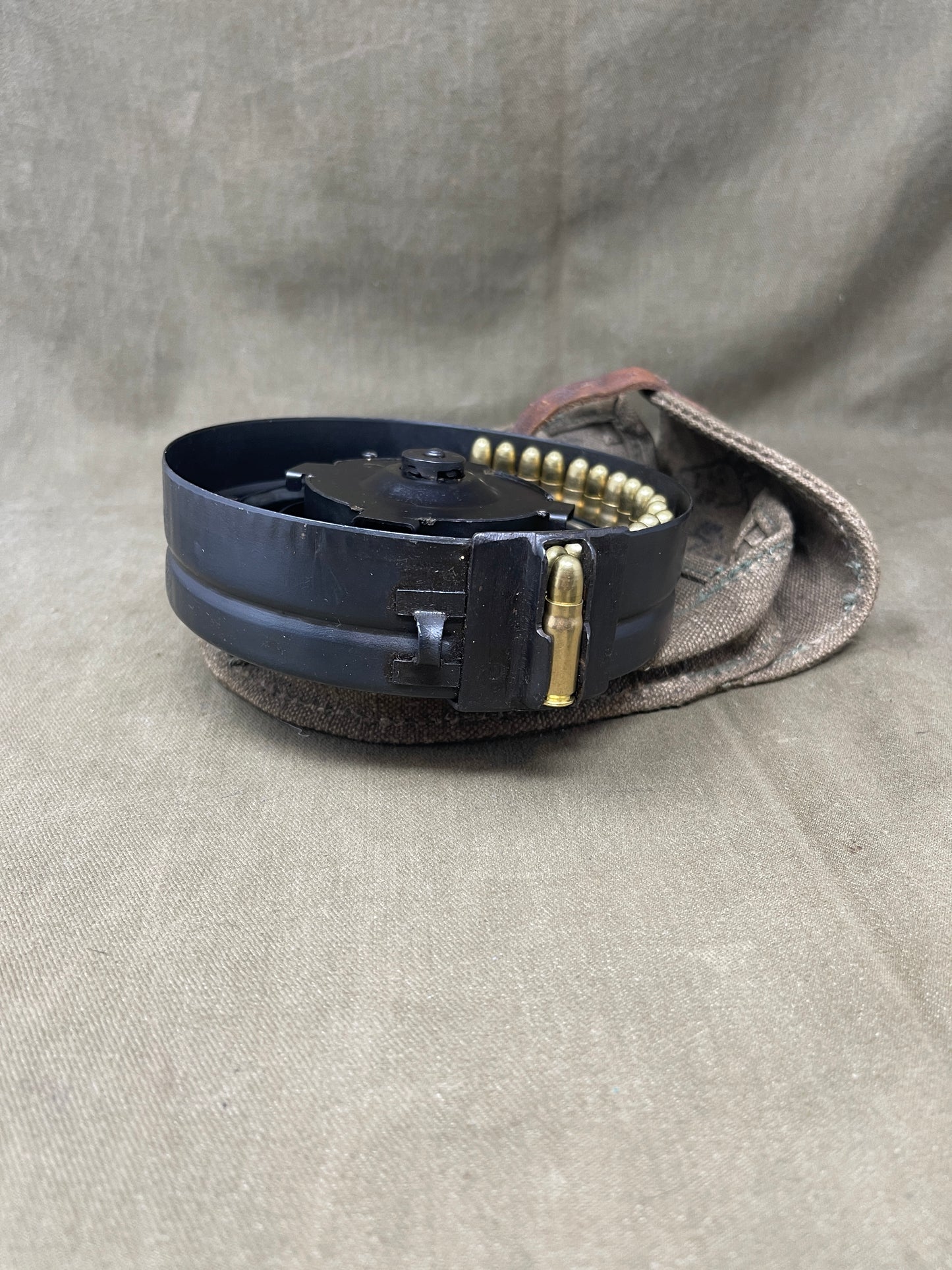 Black belt with gold buckle on a gray fabric background