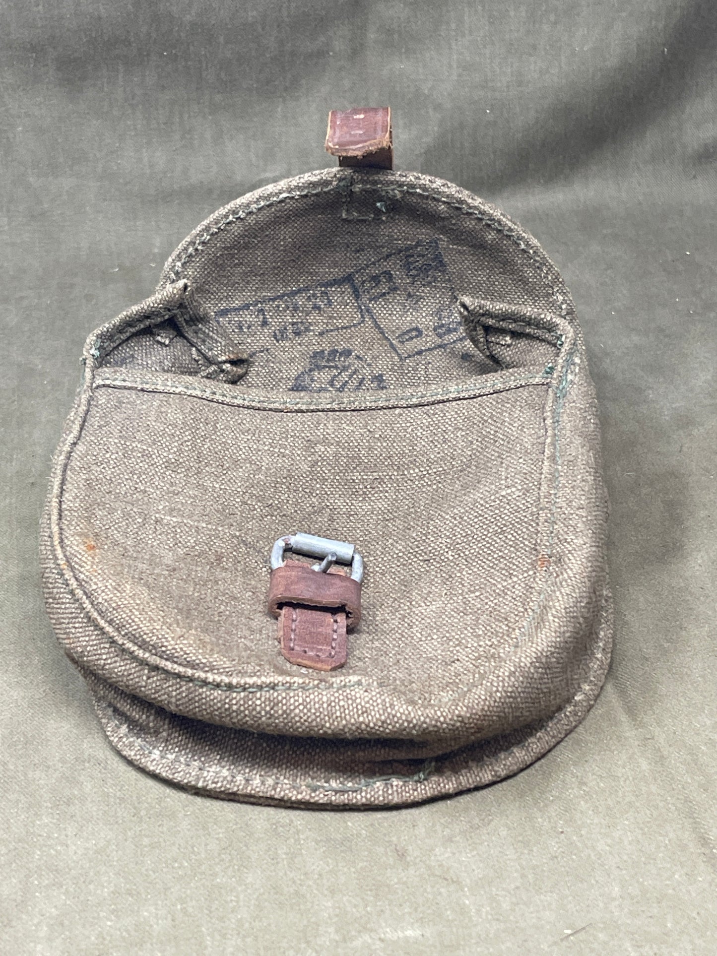 Brown leather saddlebag on a gray surface