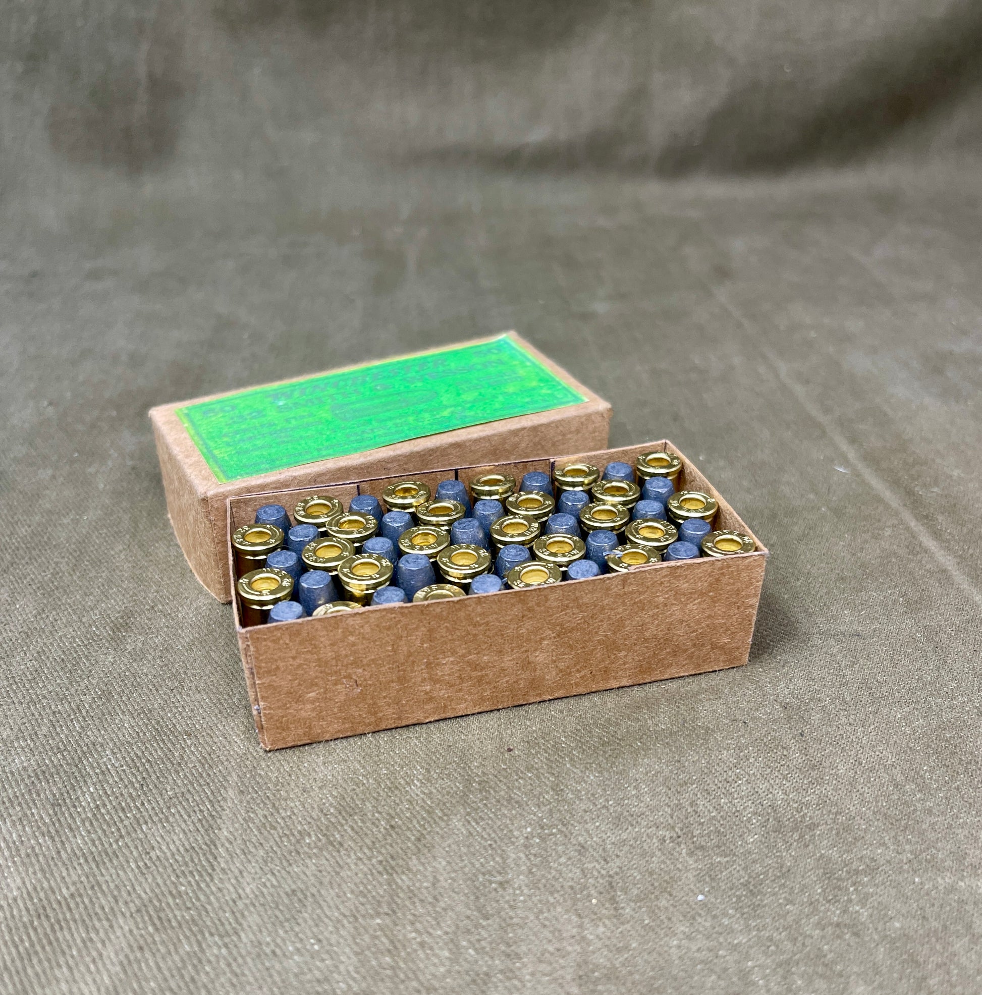 Cardboard box with small bottles on a gray background