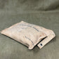 Vintage cloth pouch with text on a textured green background
