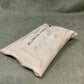 Vintage first aid kit pouch on a textured green background