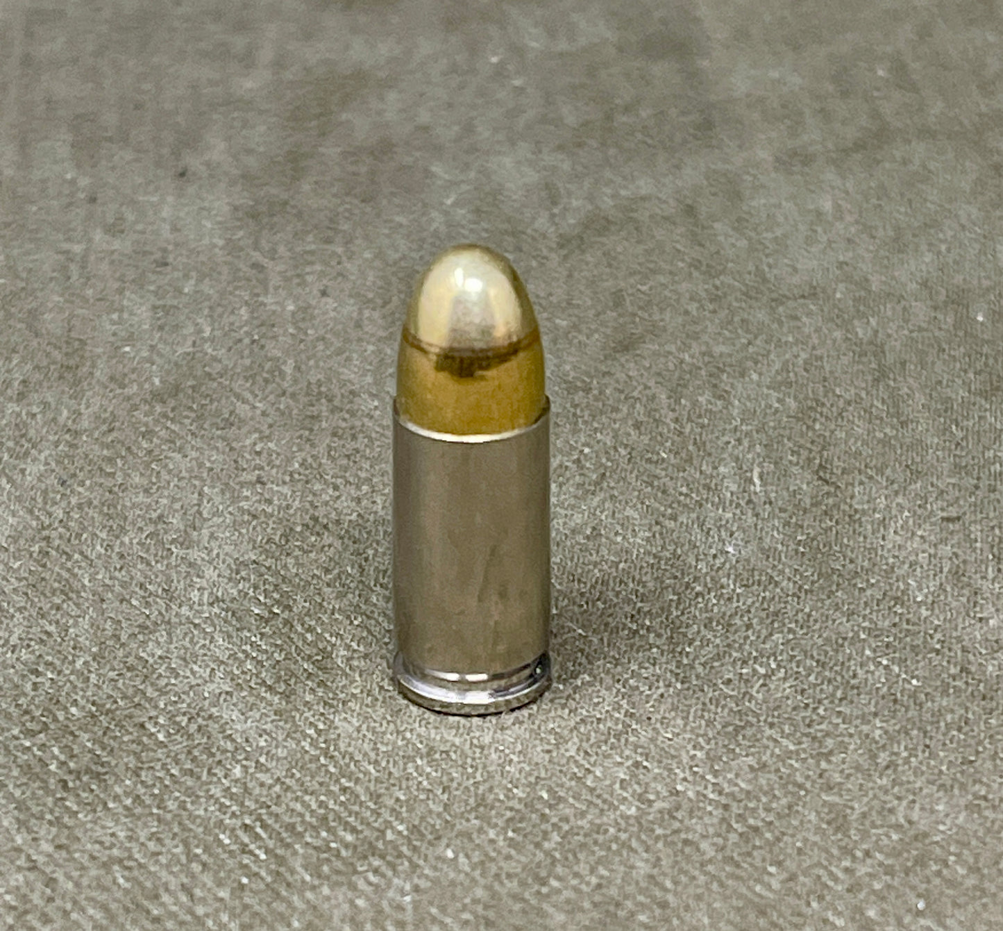 Bullet on a textured gray surface