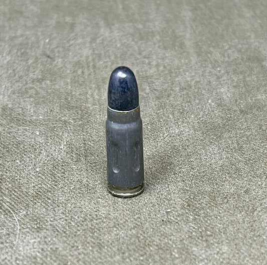 Bullet casing on a textured gray surface