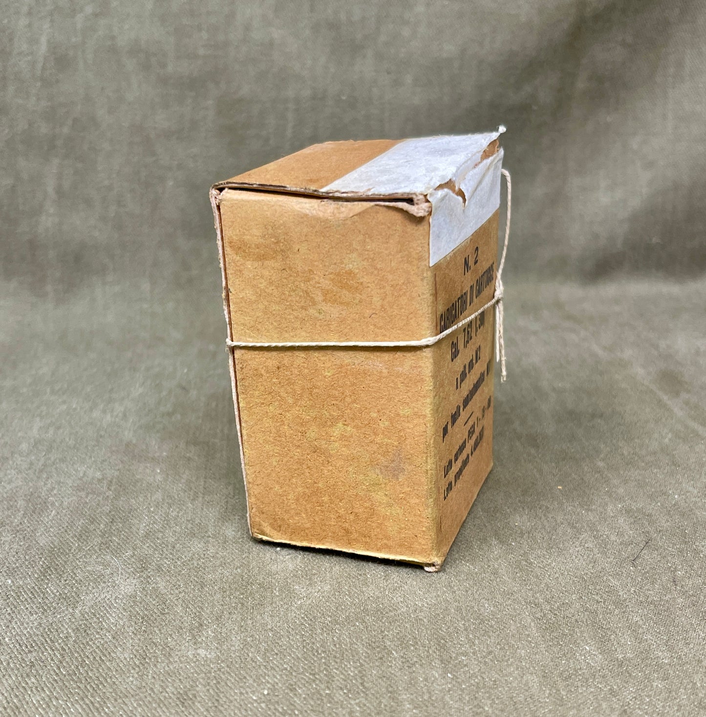 Cardboard box with a white label on a gray background