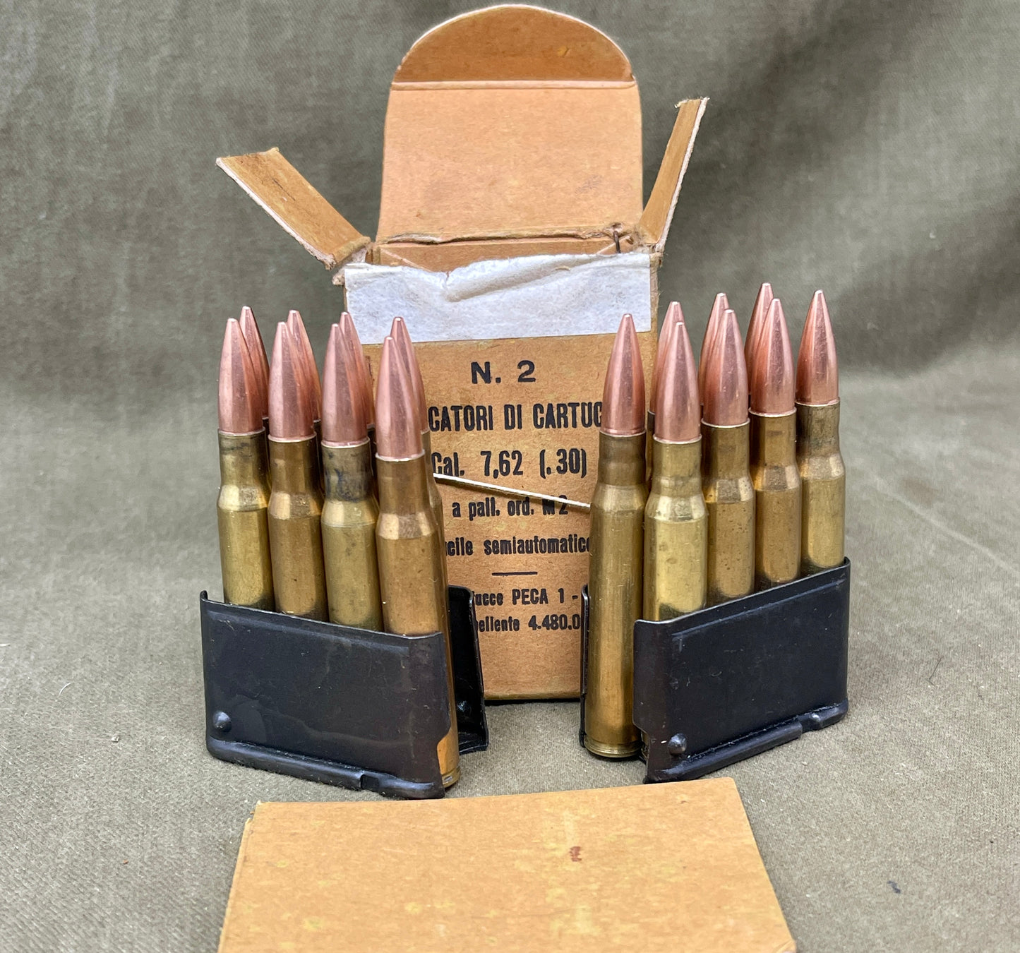 Ammunition with a cardboard box on a gray background