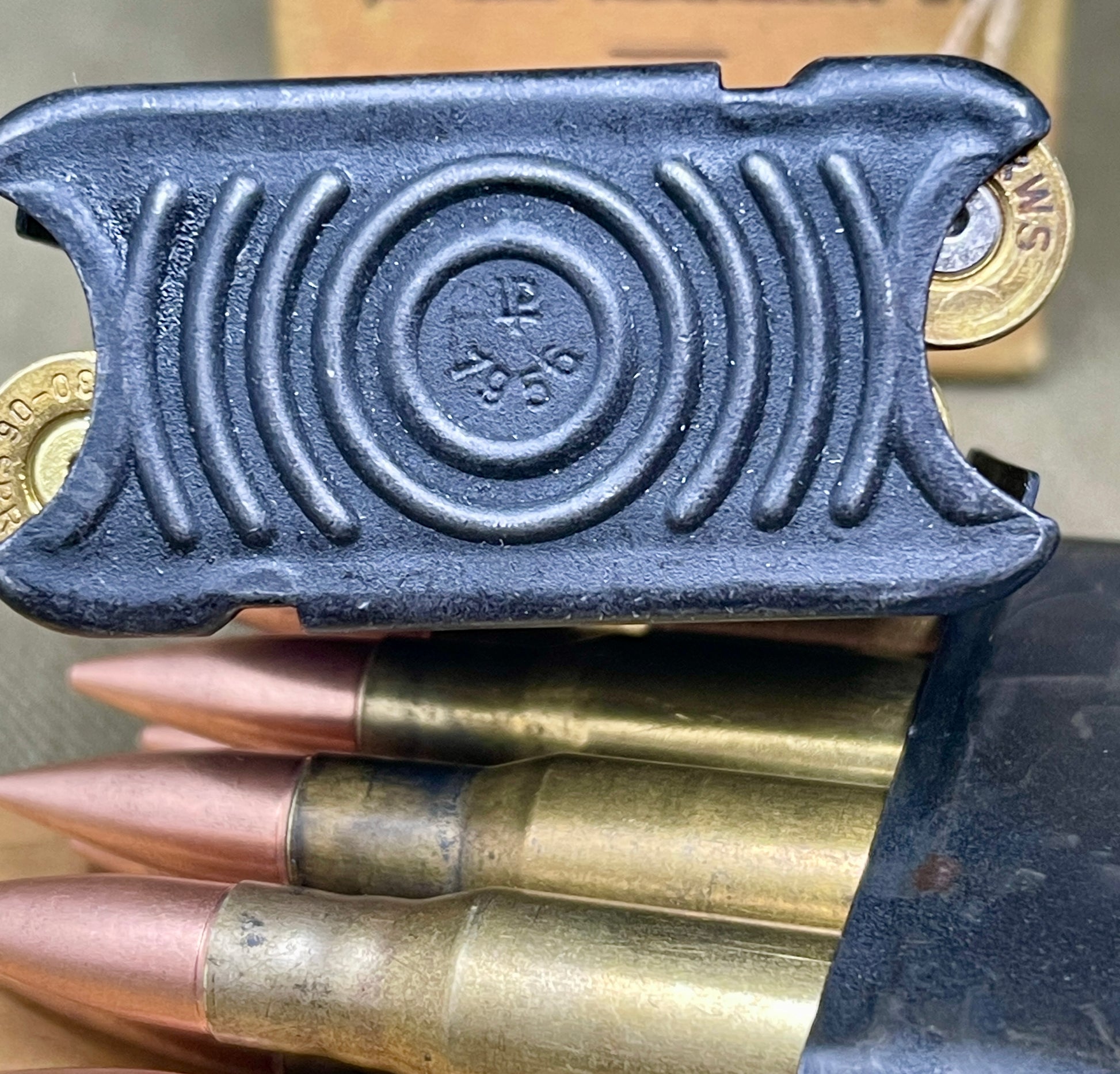 Black powder charge with brass cartridges on a wooden surface