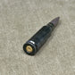 Black pen with gold clip on a gray surface