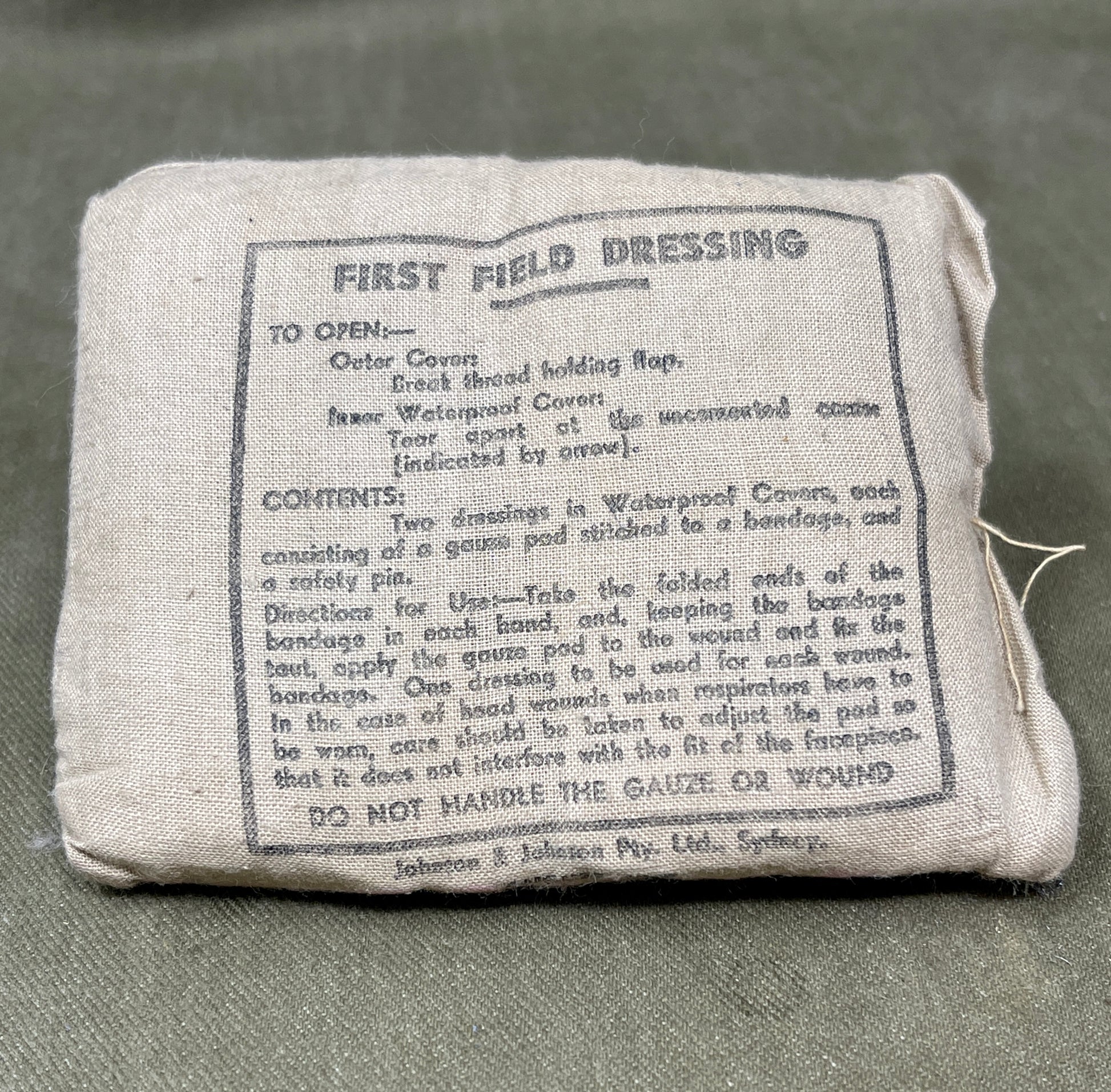 First field dressing package with text on a gray background