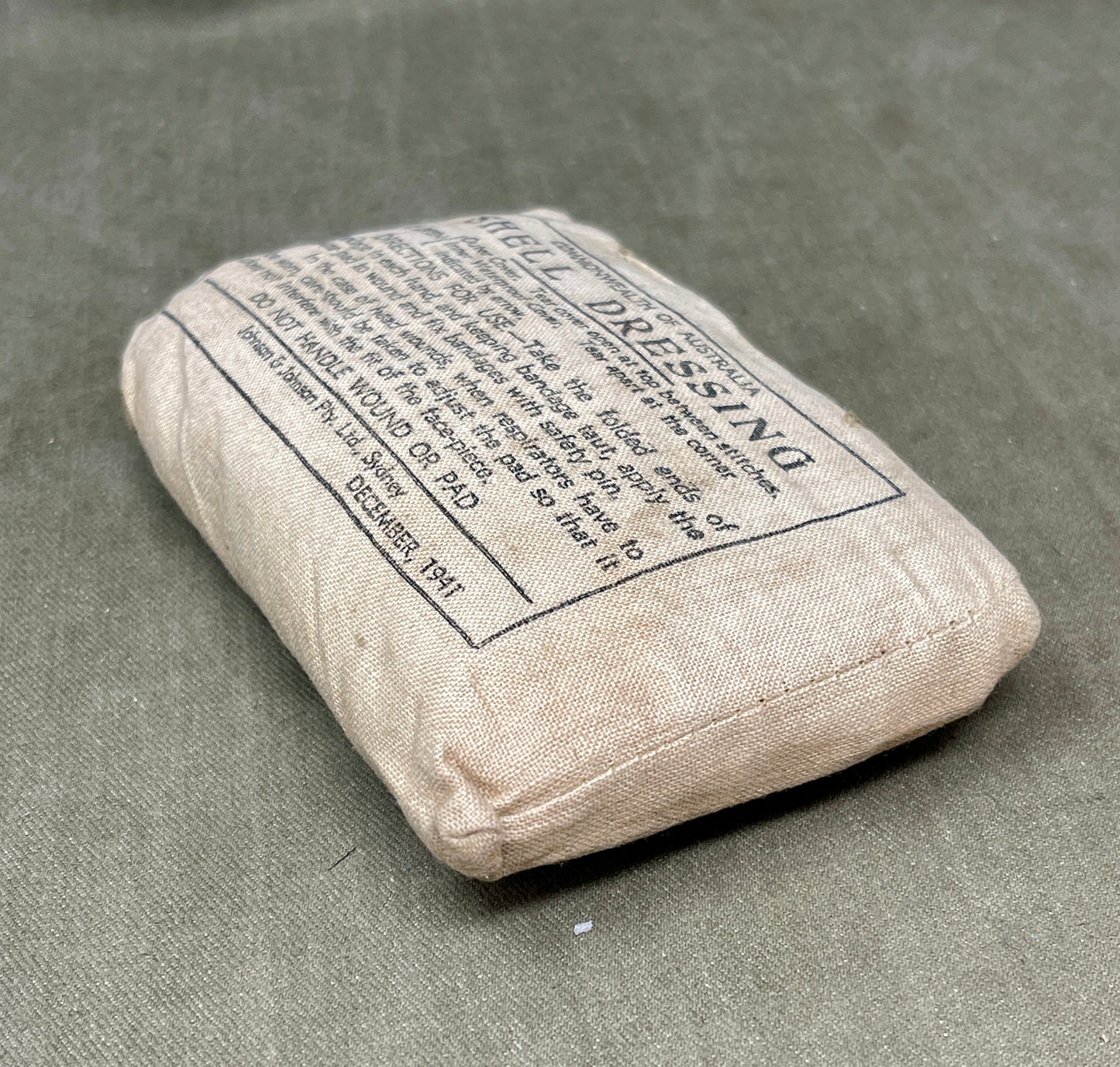 Rectangular bandage with text on a gray surface