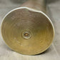 Close-up of a brass artillery shell on a gray background
