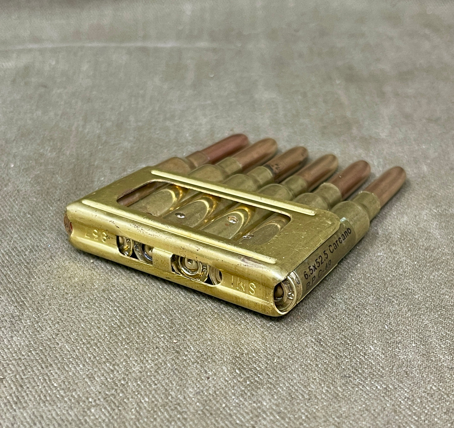 Brass reed block on a gray fabric background