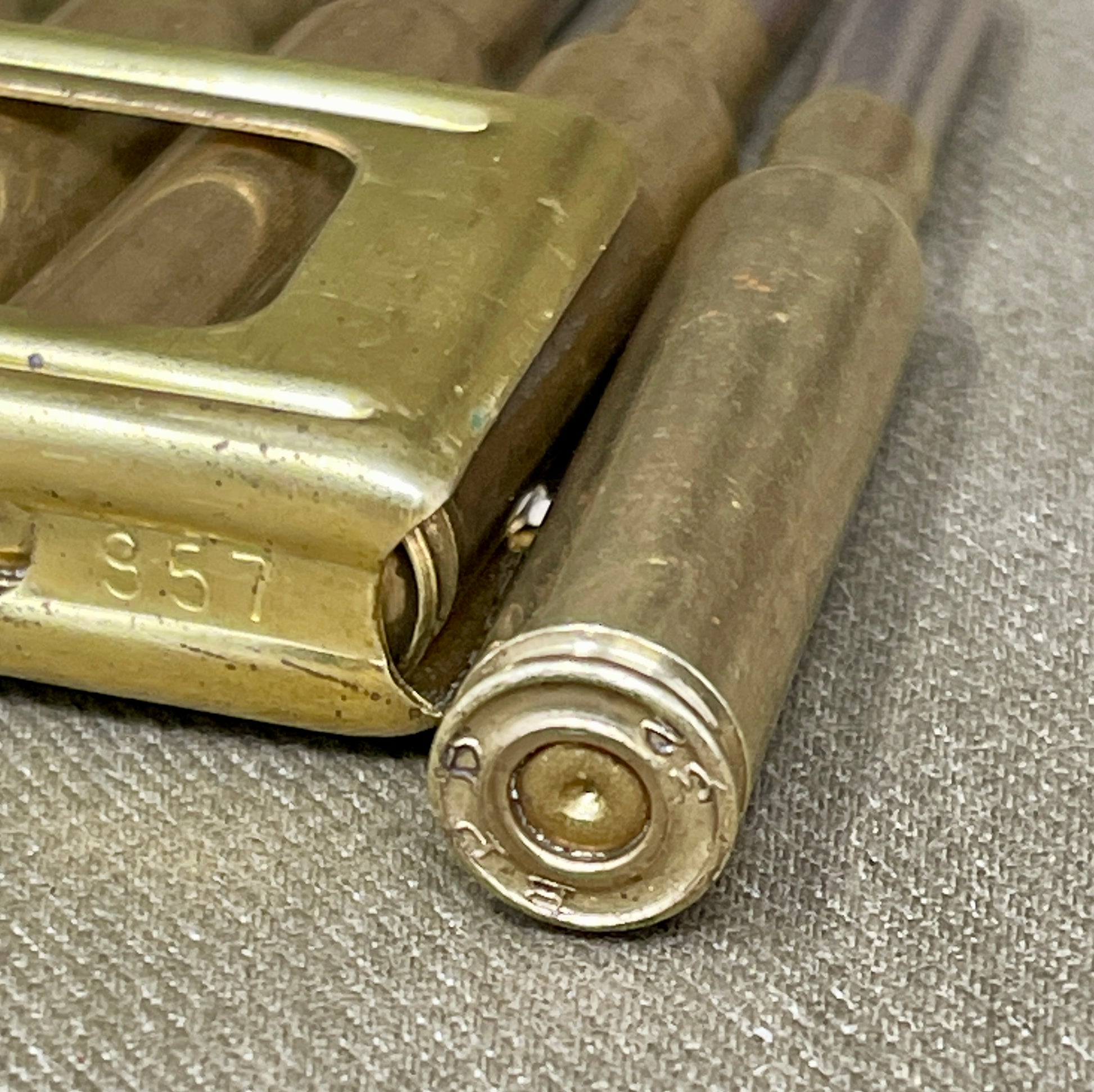 Close-up of a brass lock mechanism on a textured surface