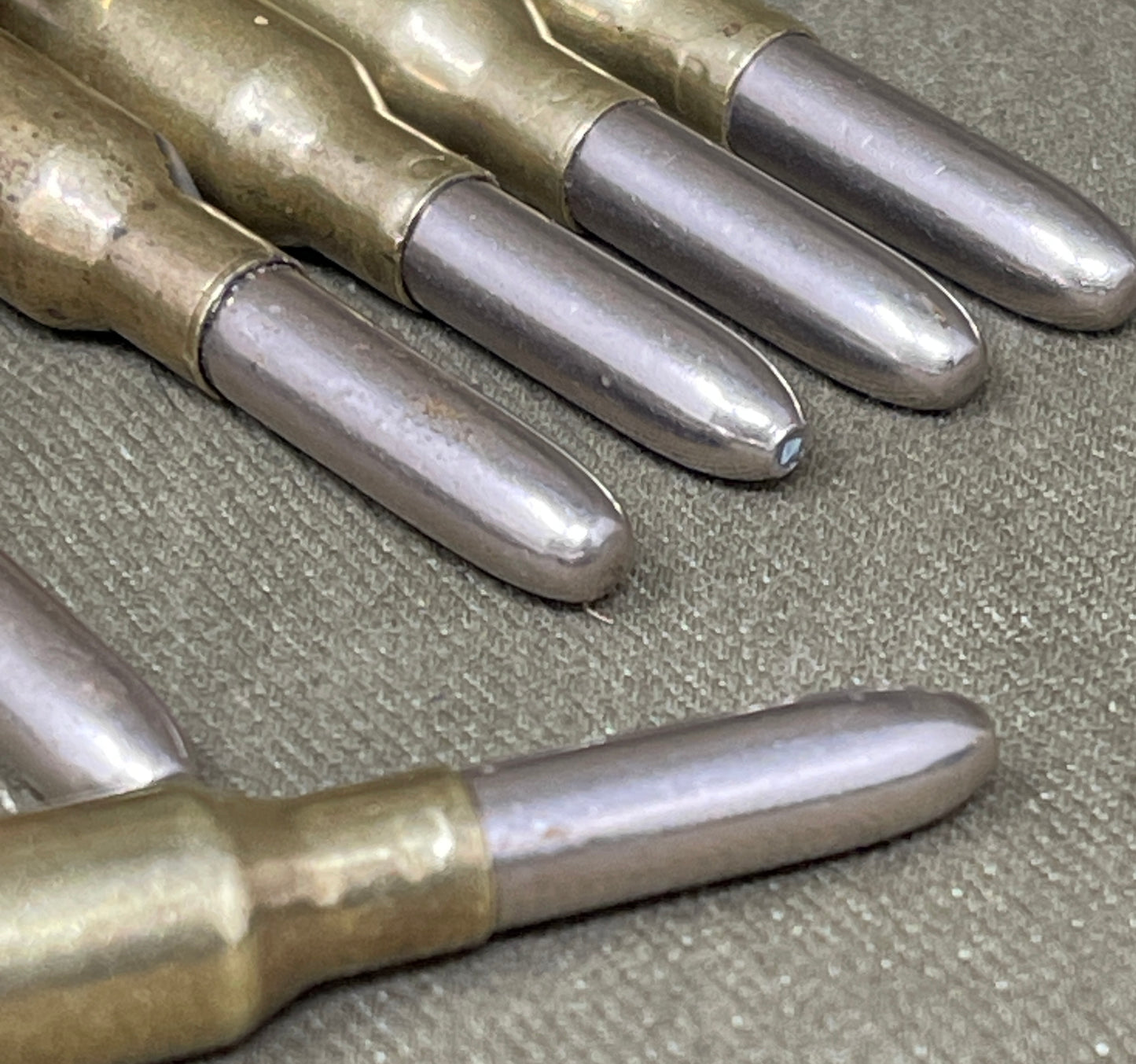 Close-up of rifle cartridges on a textured surface