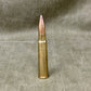Bronze bullet casing on a textured gray background