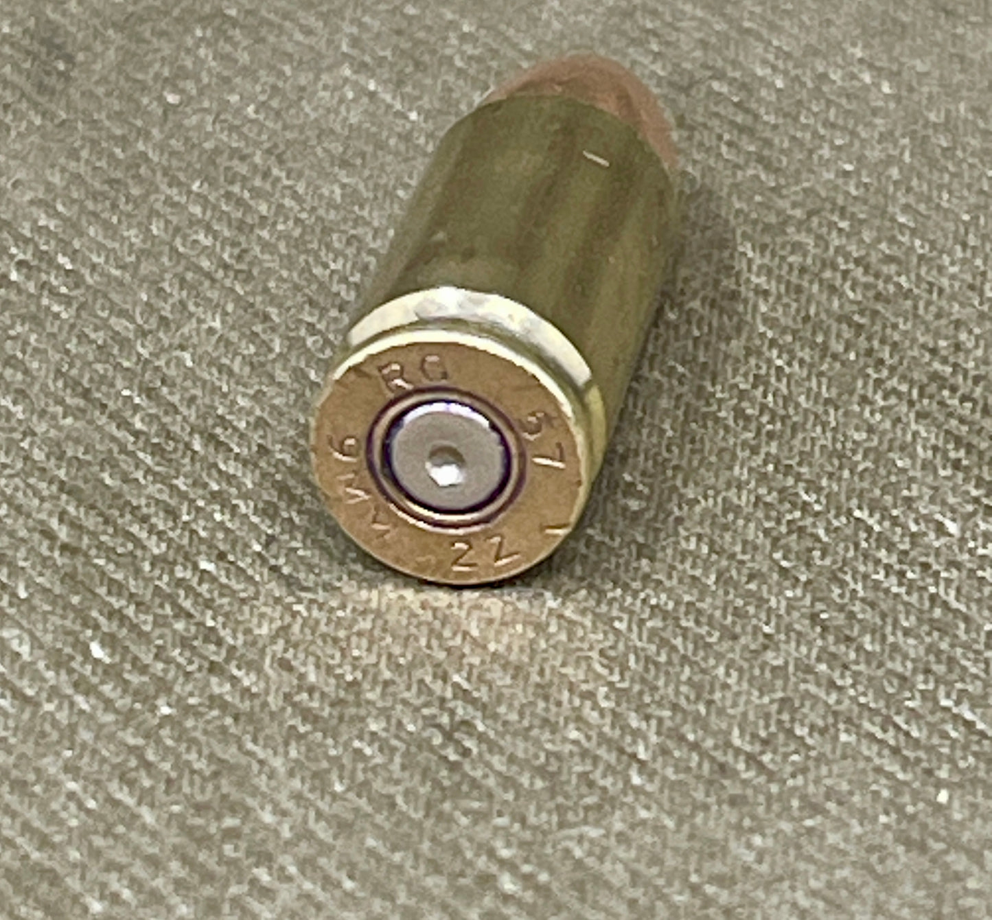 Bullet casing on a textured fabric background