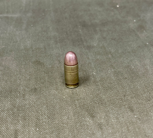 Single bullet on a textured gray surface