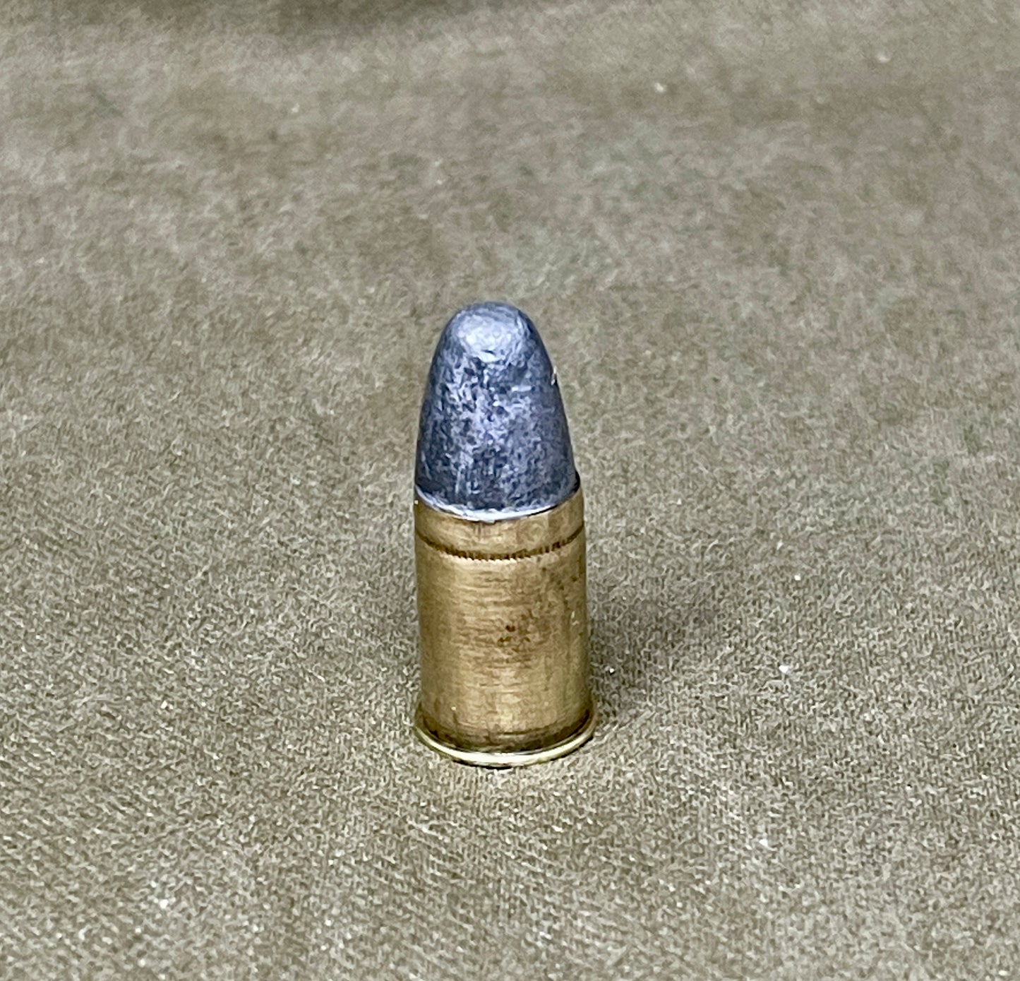 Bullet on a textured beige surface