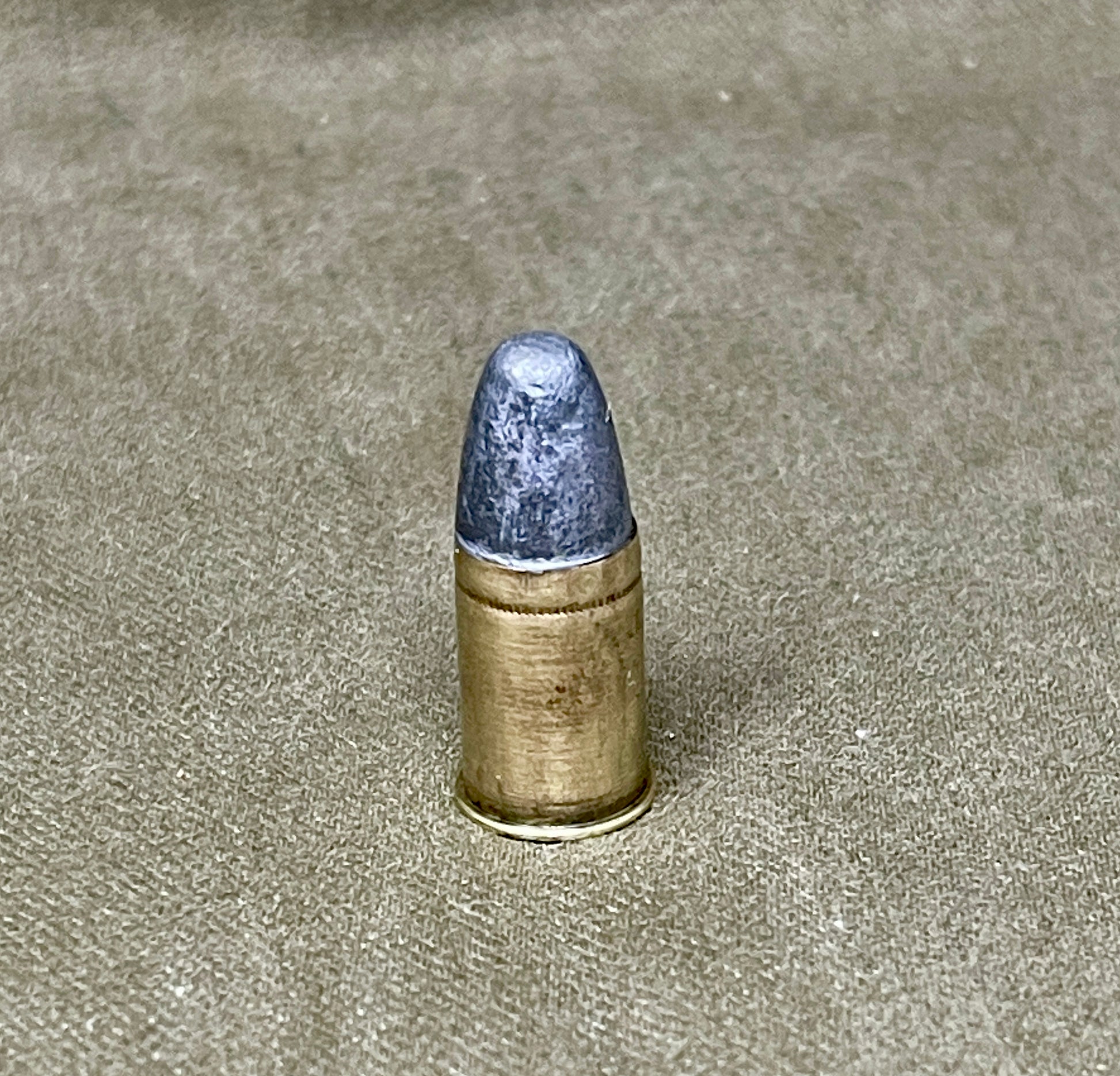 Bullet on a textured beige surface
